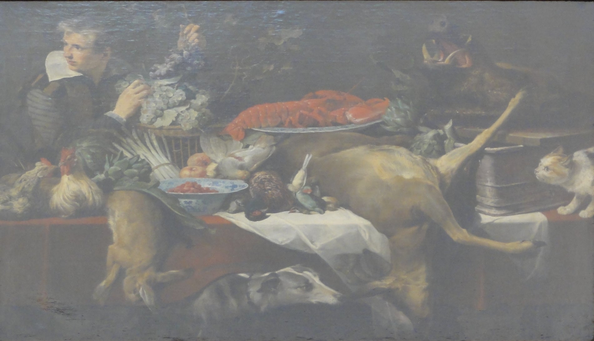 Scène de cuisine avec du gibier et des légumes, un garçon de cuisine tenant une grappe de raisin. - Frans Snyders image 1 tableau peint à l’huile sur toile